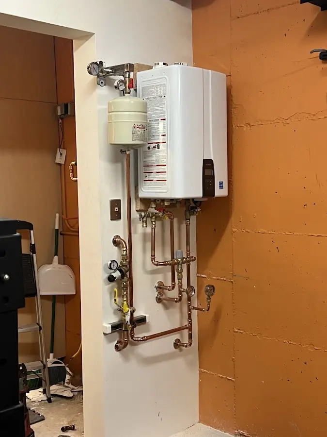 Plumbing technician inspecting water heater connections in Lebanon